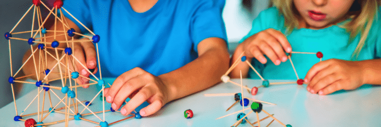 Preschool children building geometric structures with toothpicks and playdough as part of hands-on STEM learning