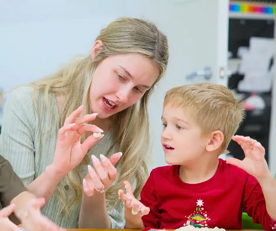 Pre-K teacher Bailey interacting with a young preschool student at STEM Child Care in Castle Rock, Colorado

