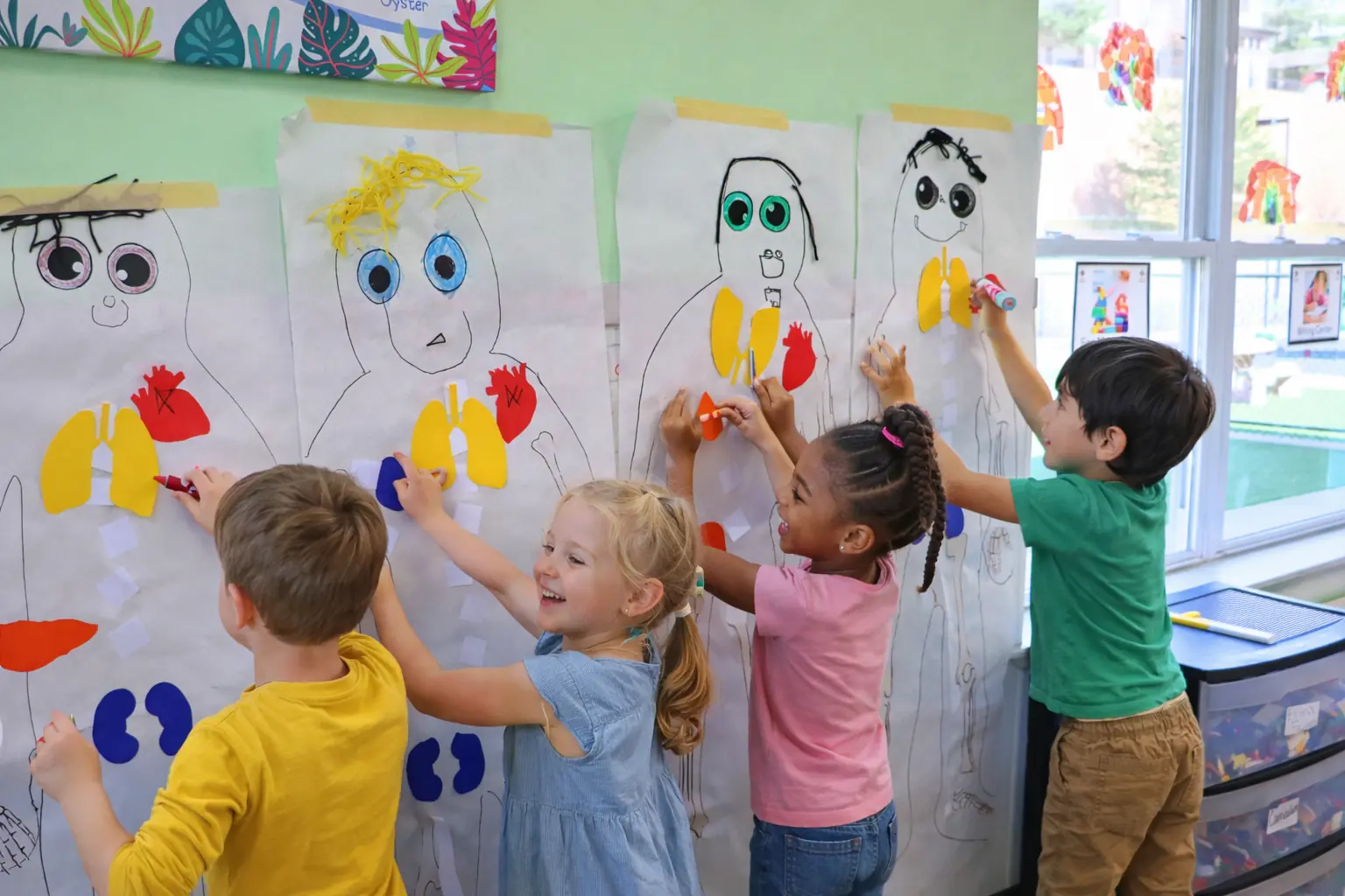 Pre-K children learning about the human body through hands-on science activity at STEM Child Care in Castle Rock Colorado