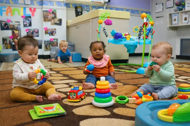 infant babies playing on classroom floor with toys at STEM Child Care Castle Rock Colorado early development environment
