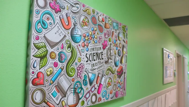 Colorful science-themed wall art and educational murals in the hallway of STEM Child Care, STEM preschool in Castle Rock, Colorado.