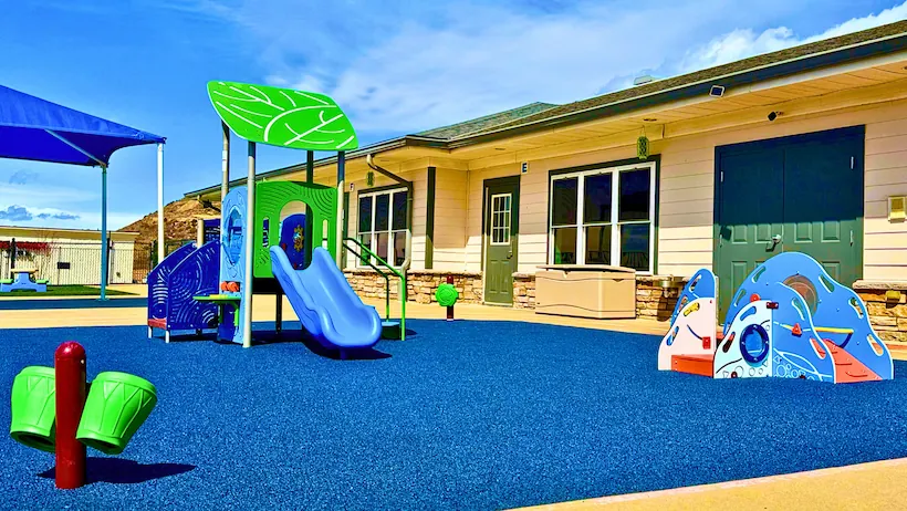Toddler playground at STEM Child Care in Castle Rock, CO with age-appropriate play equipment and soft surface.
